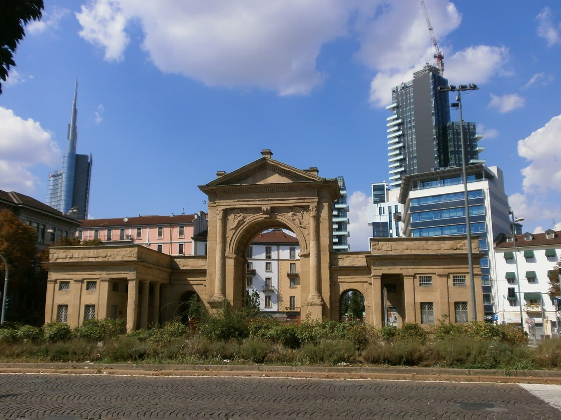 The Porta Nuova arch against Milan's modern towers